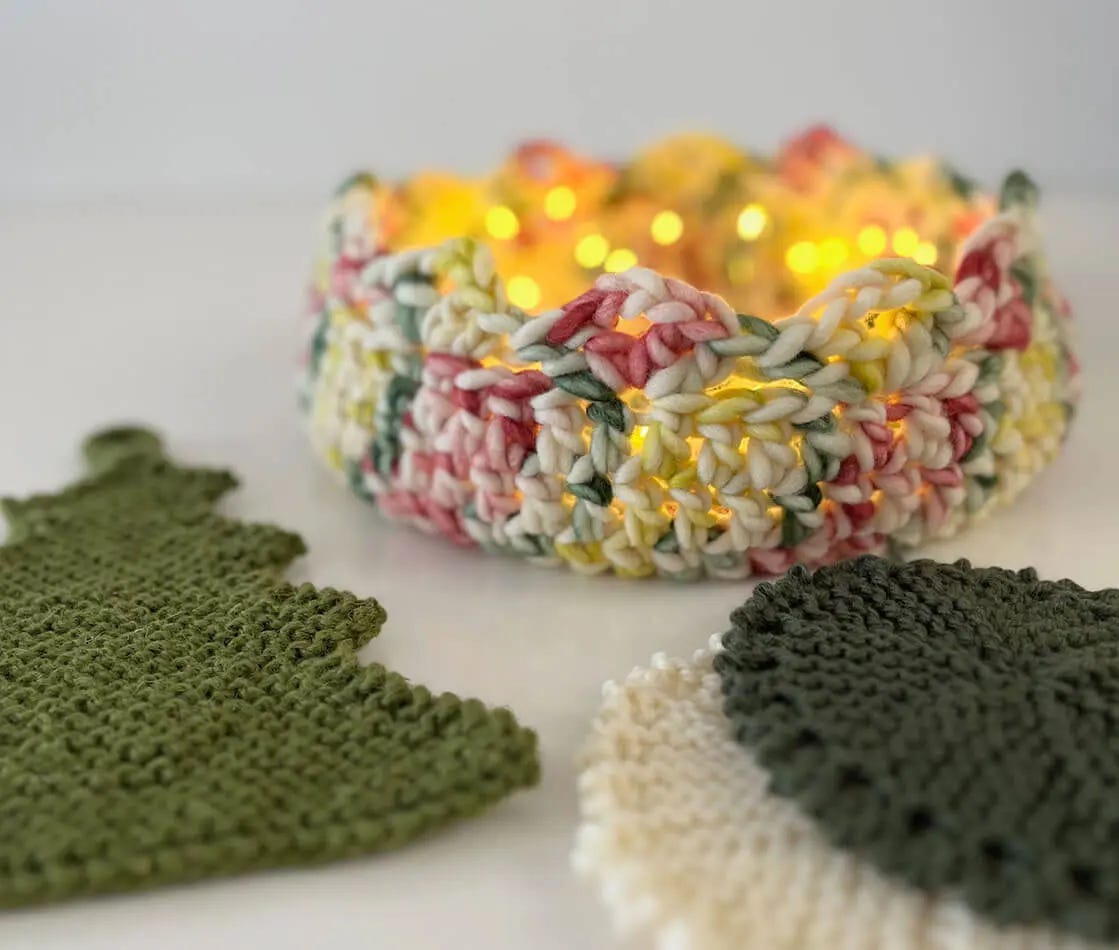a knitted potholder, a crochet basket and two knitted trivets