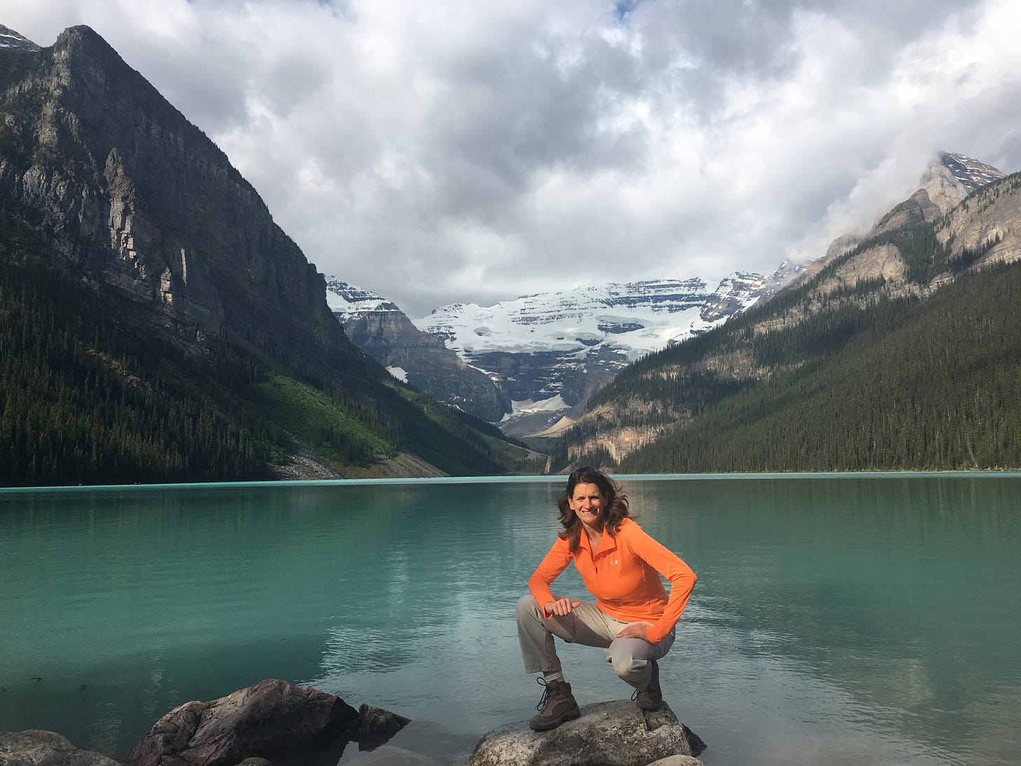 Lake Louise shoreline with visitors and limited parking access in Banff