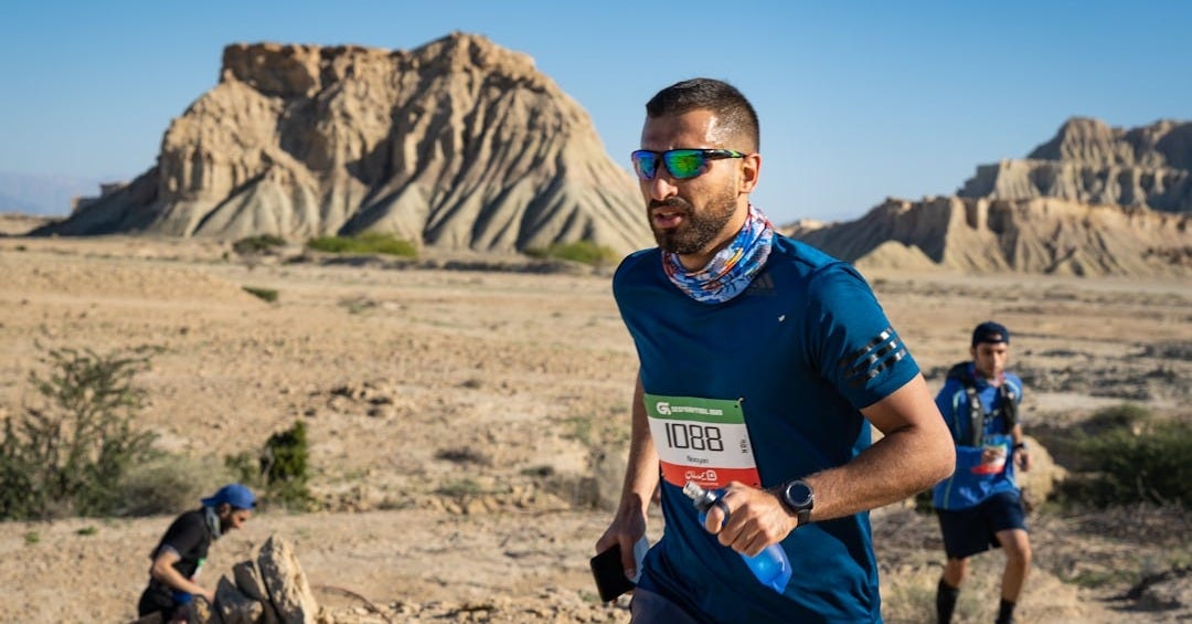 man in blue crew neck t-shirt and black sunglasses holding a bottle man in blue crew neck t-shirt and black sunglasses holding a bottle