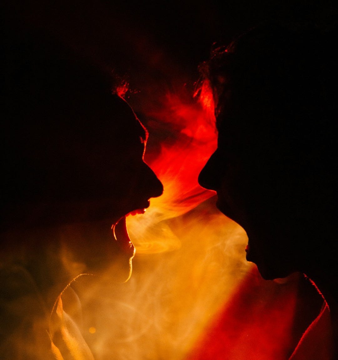 a couple of people that are kissing in the dark a couple of people that are kissing in the dark