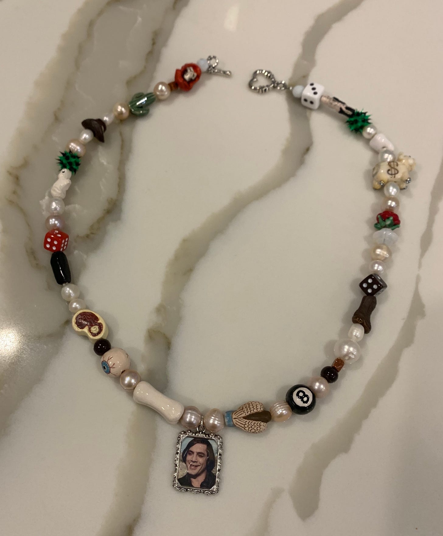 An Ian Charms necklace of Anton Chigurh from 'No Country for Old Men'