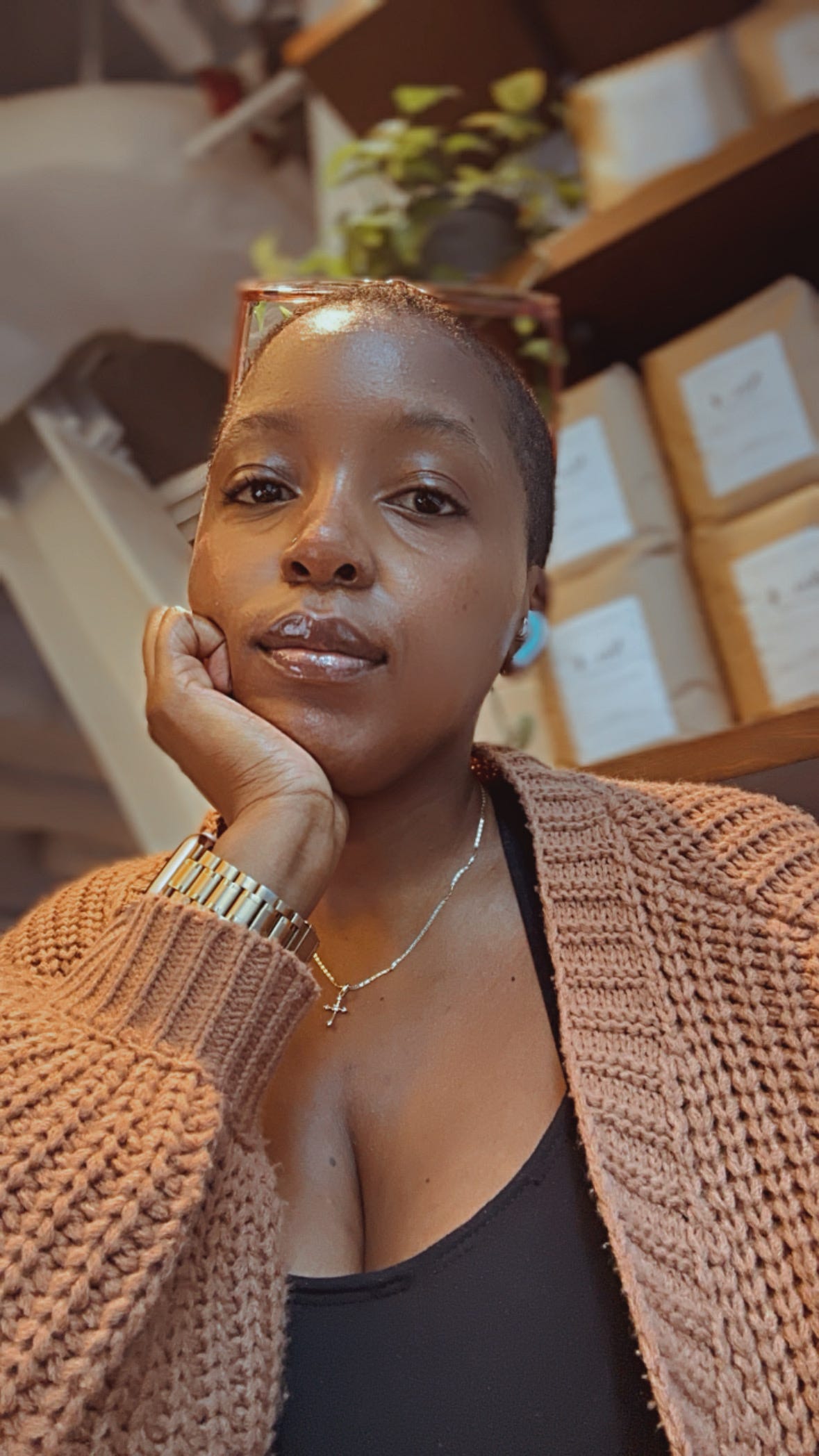 Description: This is a close-up selfie of me wearing a coxy brown sweater. My hair is short, and I'm looking directly at the camera with a calm but slightly tired expression. The lighting is soft, giving the photo a peaceful atmosphere.