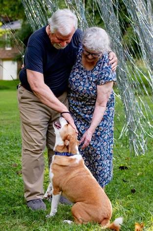 A person and person petting a dog

AI-generated content may be incorrect.