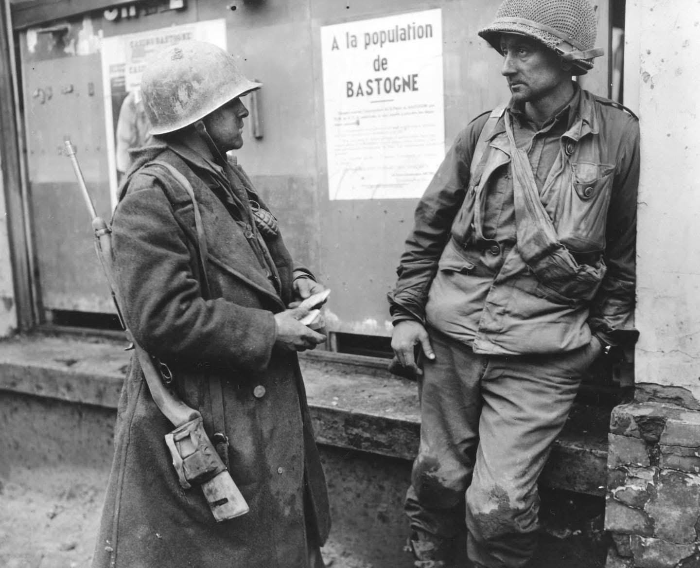 Exhausted GIs Adam Davis (left) and Milford Sillars of the 110th Regiment, 28th Infantry Division, taking a much-needed break in Bastogne, Belgium, during the intense fighting of December 1944.