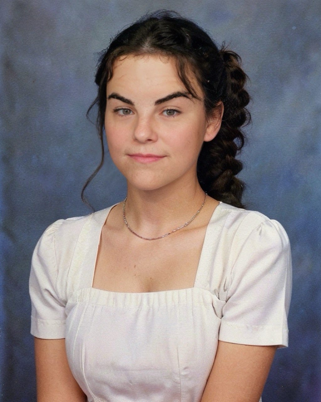 An AI-generated image of myself through Epik, of myself as a young woman wearing a white top.