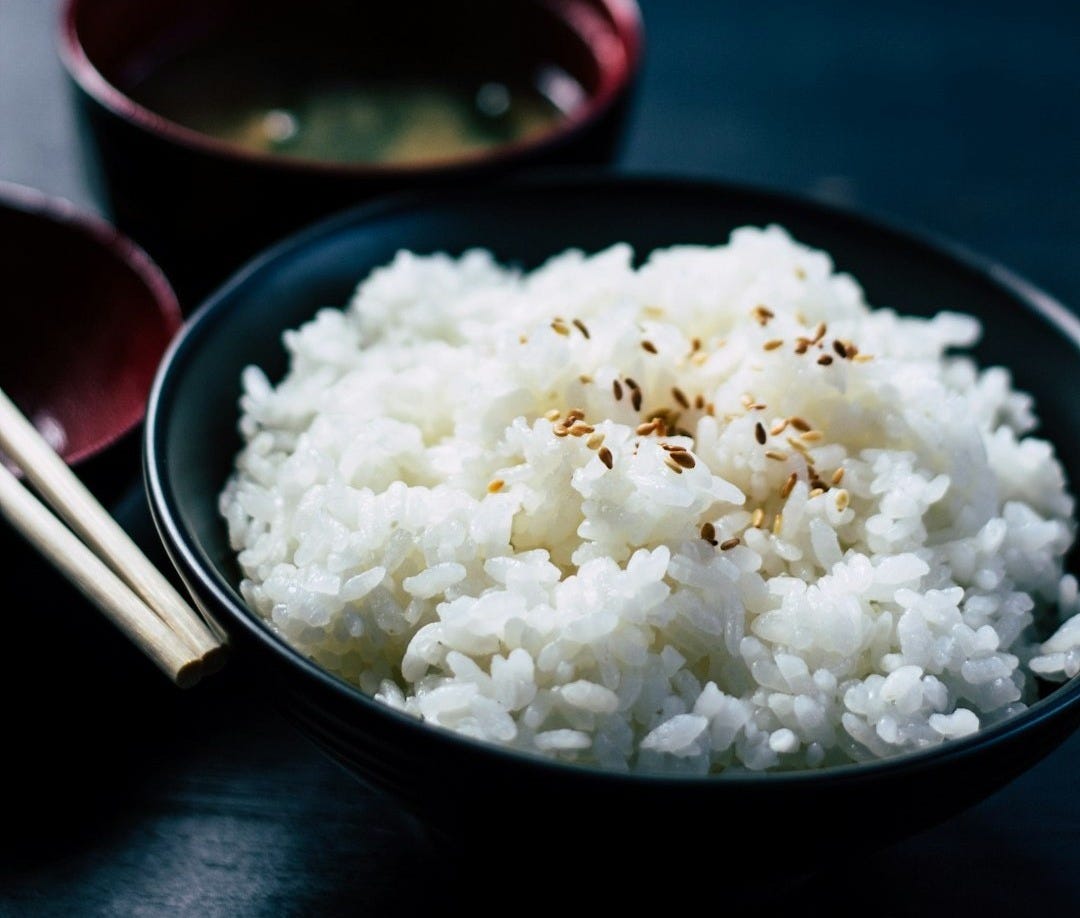 rice with sesame in black bowl rice with sesame in black bowl