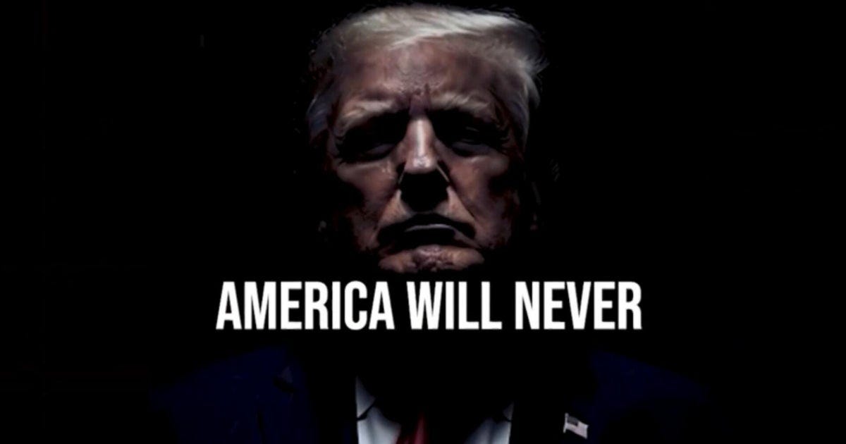 Still from a taxpayer-funded ad showing Trump with the text AMERICA WILL NEVER Still from a taxpayer-funded ad showing Trump with the text AMERICA WILL NEVER