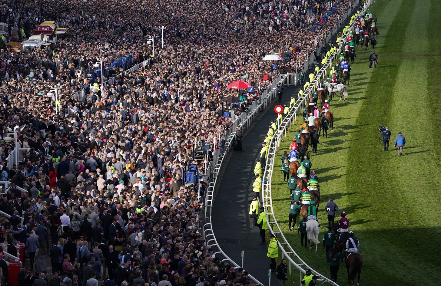 Sell-out crowd cheers on Grand National as punters return to races | The  Independent