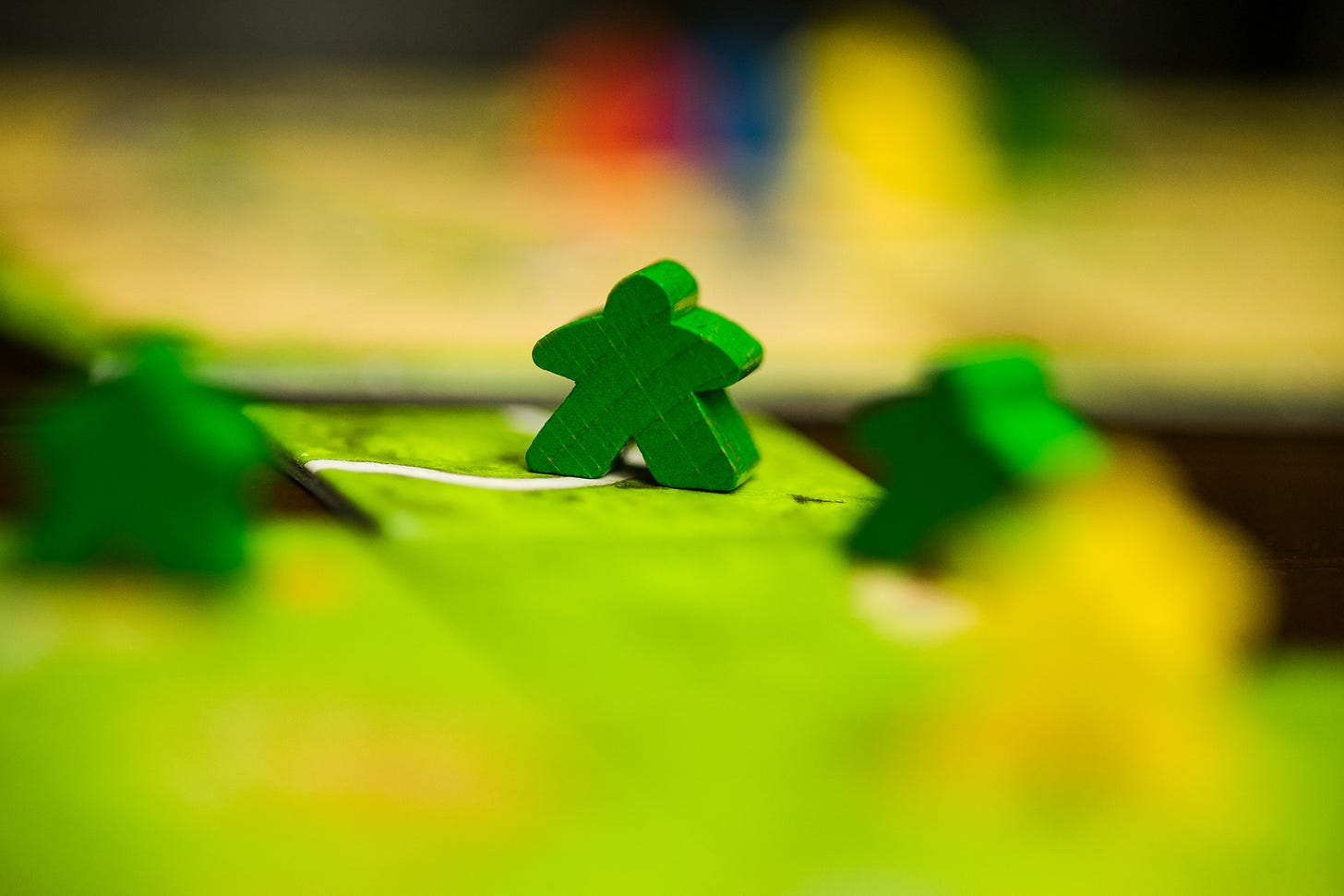 Pieces from the board game Carcassonne, with some in the foreground out of focus.