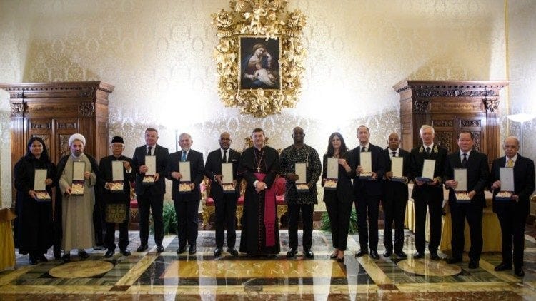 The ambassadors pose for a photograph with Archbishop Paolo Rudelli 