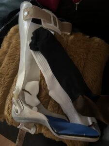 Semi-customized brace for my paralyzed left foot by Hanger Clinic. Not sure of country of origin. White cotton athletic sock from Costco and compression hose for my left foot from Big 5 sporting goods. Both made in China.