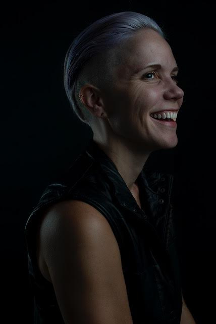 Sarah Perry smiling with purple hair