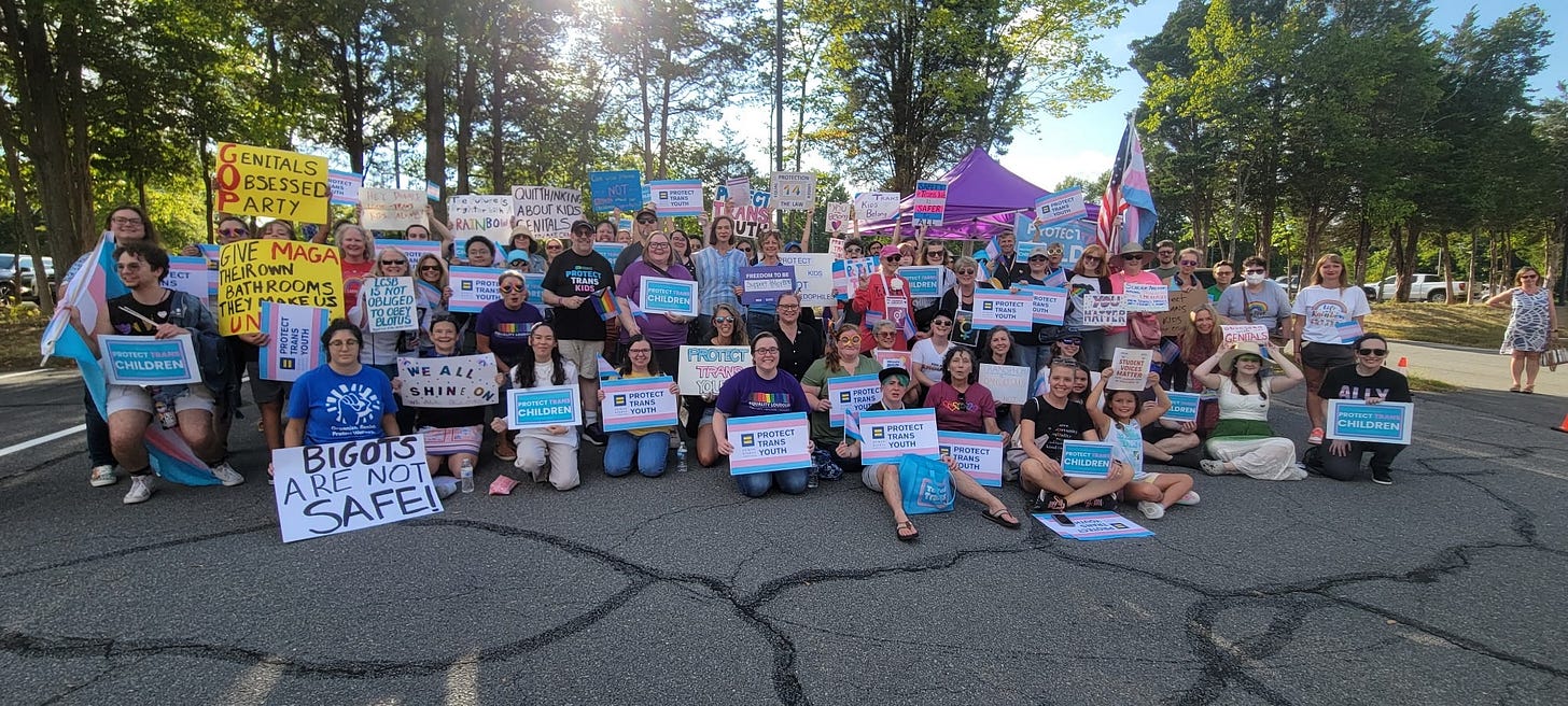 May be an image of 3 people and text that says 'ENITALS BSESSED ARTY MAGA FIROWN BATHROOMS CHILDREN ELCIUS CHиИ rOTEC WE WEALL SHINE PROMCT HRDREN E PACTEET YDUTH A ARE BIGOTS NOT SAFEI GINING 0 대습명다 TиA4B YOUTH OUTH PROTEET PRSTECE CHILDREN'