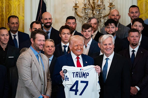 President Donald Trump, center, holds a baseball jersey alongside Clayton Kershaw, pitcher for the Los Angeles Dodgers, left, and Mark Walter, owner...