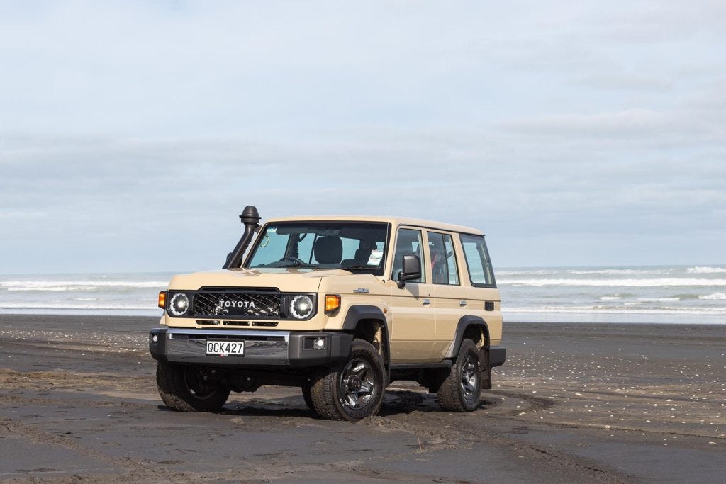 2024 Toyota Land Cruiser 70 LX Wagon parked on a Kiwi beach 2024 Toyota Land Cruiser 70 LX Wagon parked on a Kiwi beach