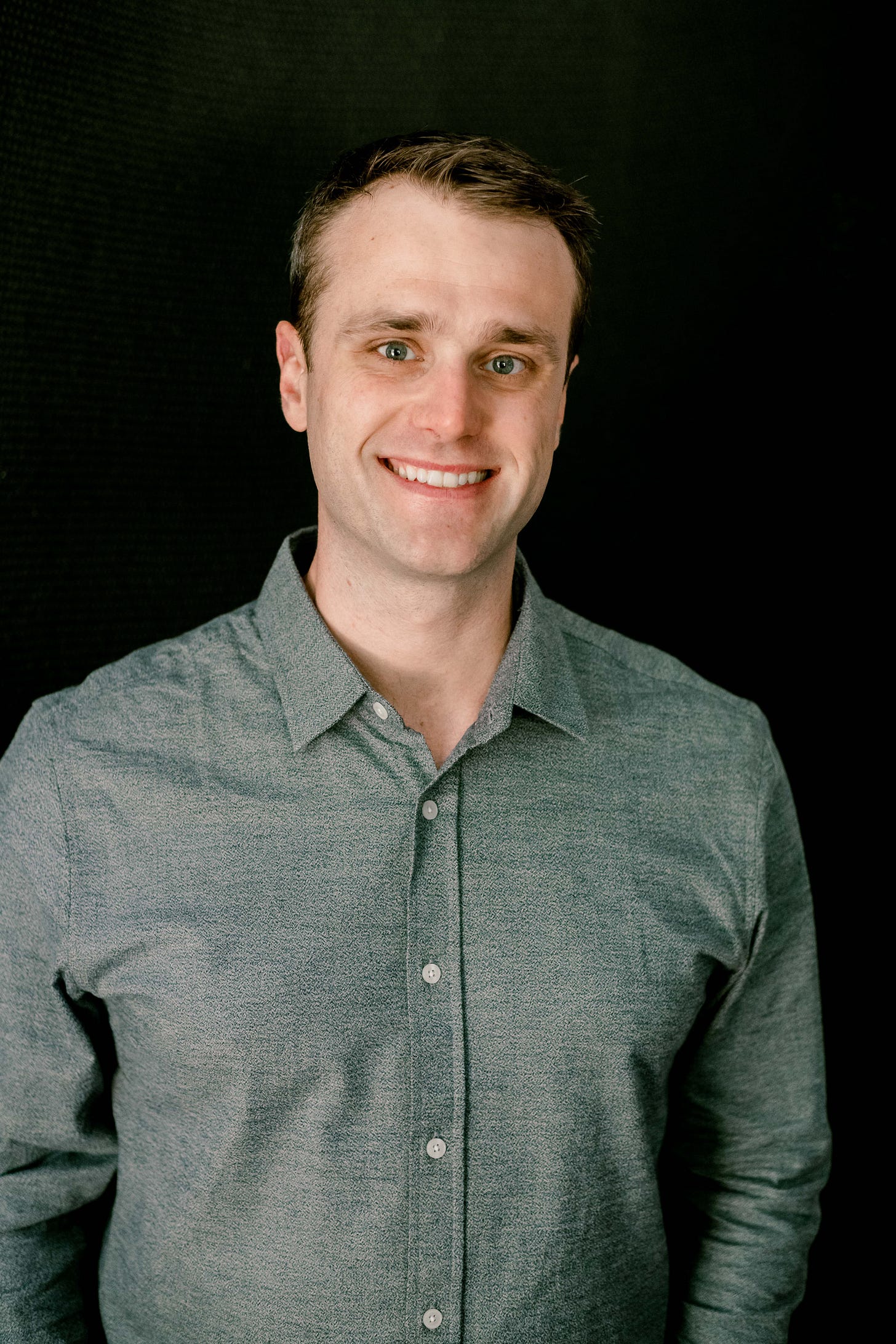 A man smiles at the camera A man smiles at the camera