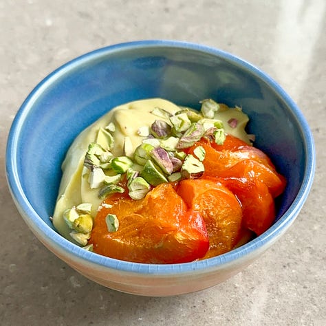 A bowl with chamomile pudding, a bowl with roasted apricots and chamomile pudding, a bowl with with roasted apricots and chamomile pudding topped with chopped pistachios.