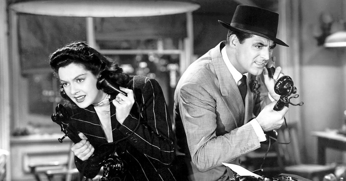 Rosalind Russell and Cary Grant on the phone, facing off in a still from His Girl Friday (1940).