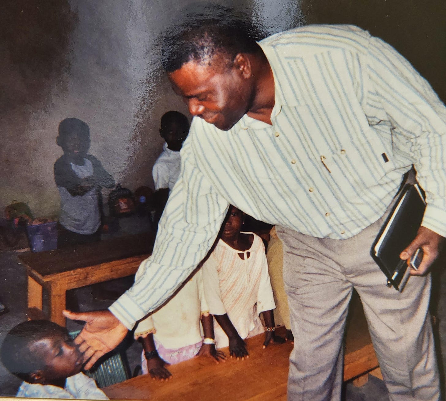 Man greeting child in West Africa