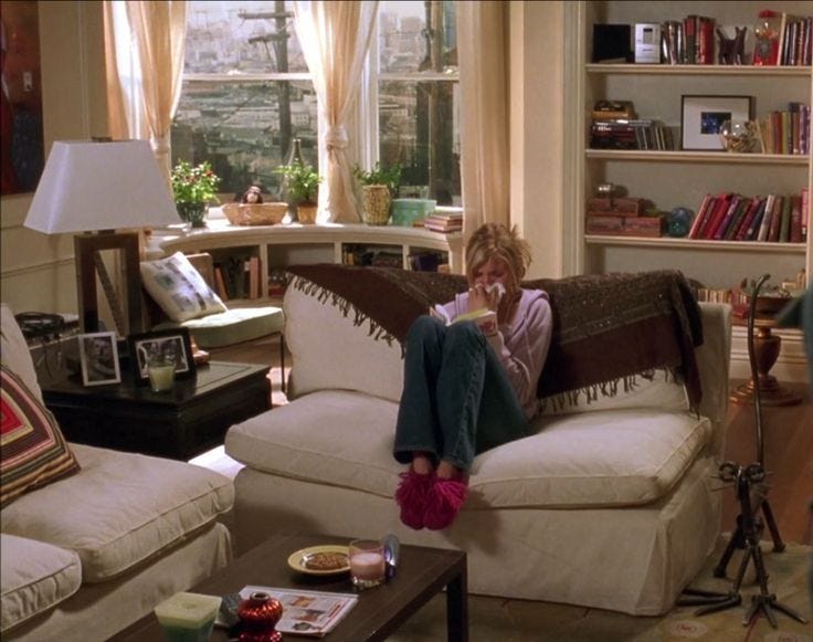 This may contain: a woman sitting on top of a couch in a living room This may contain: a woman sitting on top of a couch in a living room