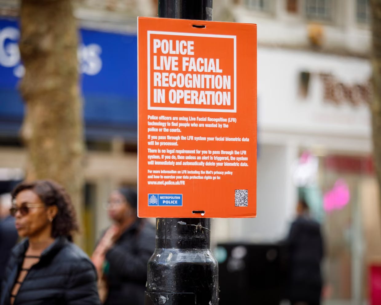 An orange sign in London announces facial recognition in use An orange sign in London announces facial recognition in use