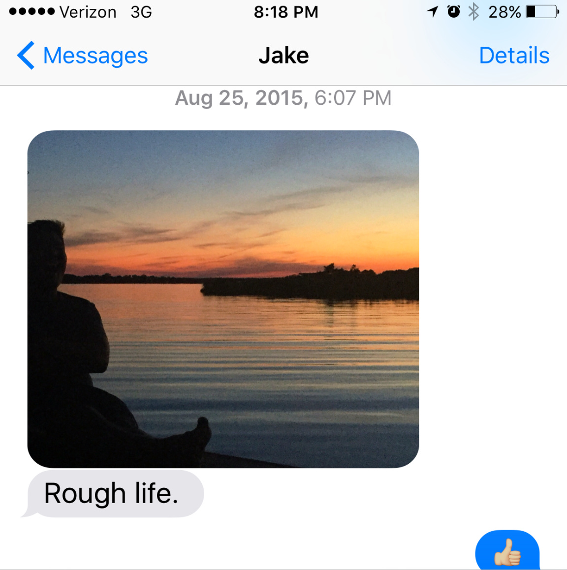 a photo of a screenshot of a phone that is a text message exchange between the author and Jake Brewer with a photo of the author looking out over the sunset and water and the text from Jake that says "rough life."
