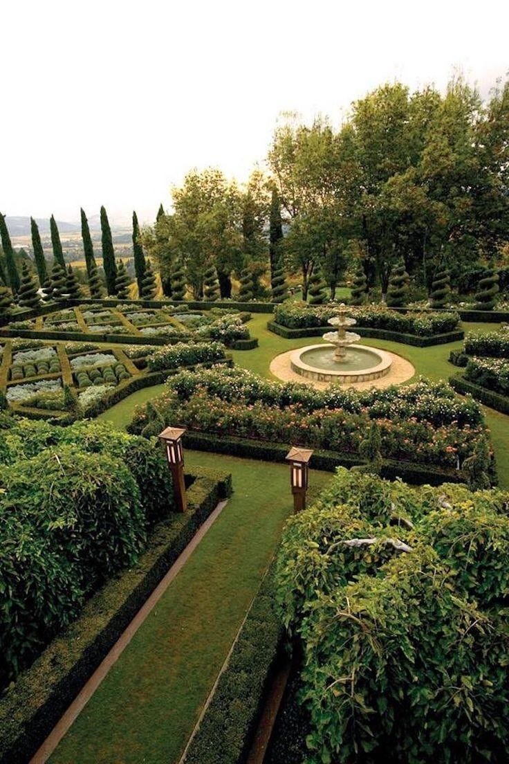 This may contain: a formal garden is shown in the middle of an area with many hedges and trees This may contain: a formal garden is shown in the middle of an area with many hedges and trees