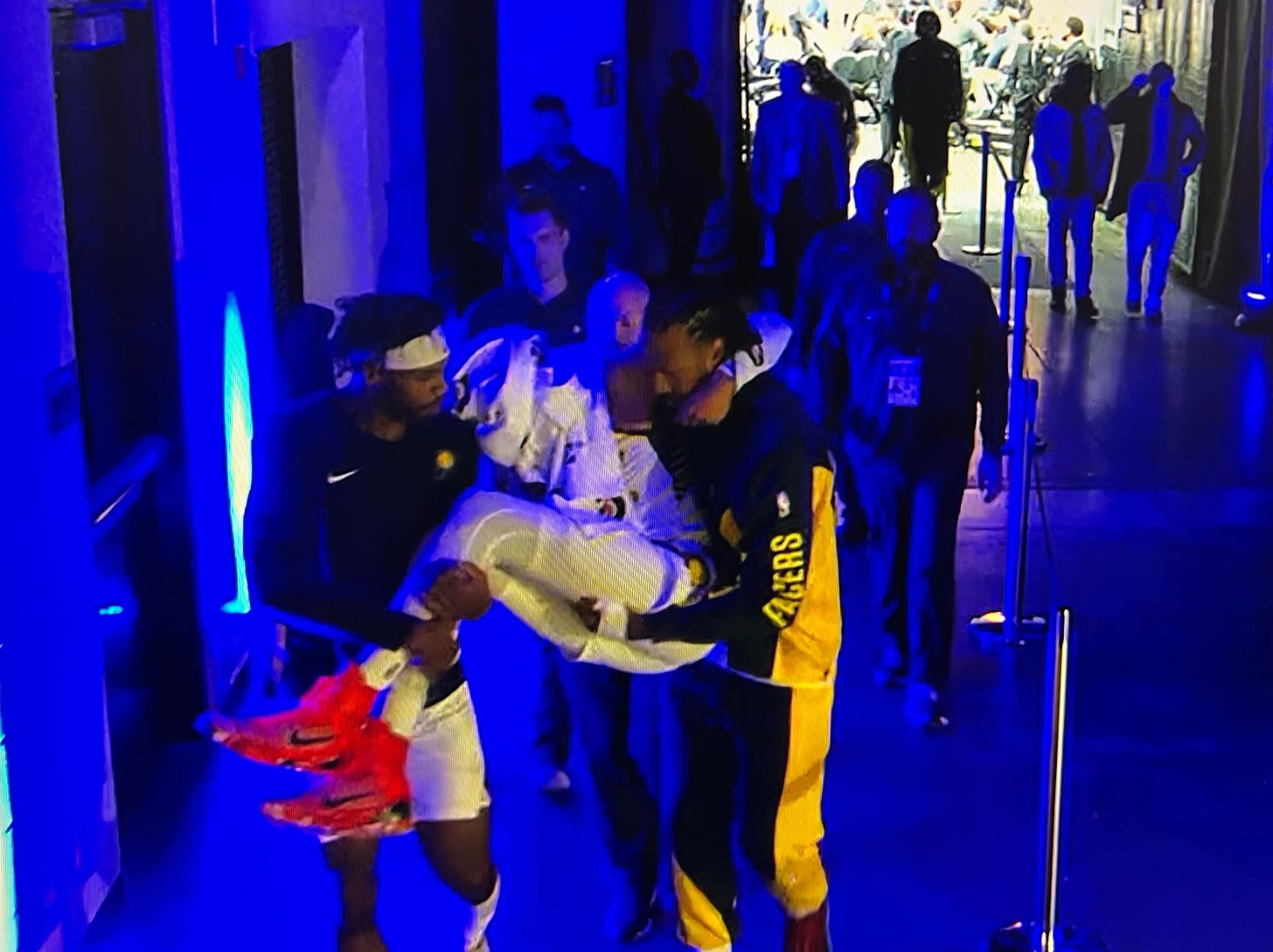 Buddy Hield and James Johnson carried Haliburton back to the locker room.