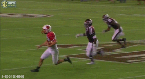 A GIF of an American footabll players being tackled and then front-flipping over the shoulders of the tackling player A GIF of an American footabll players being tackled and then front-flipping over the shoulders of the tackling player