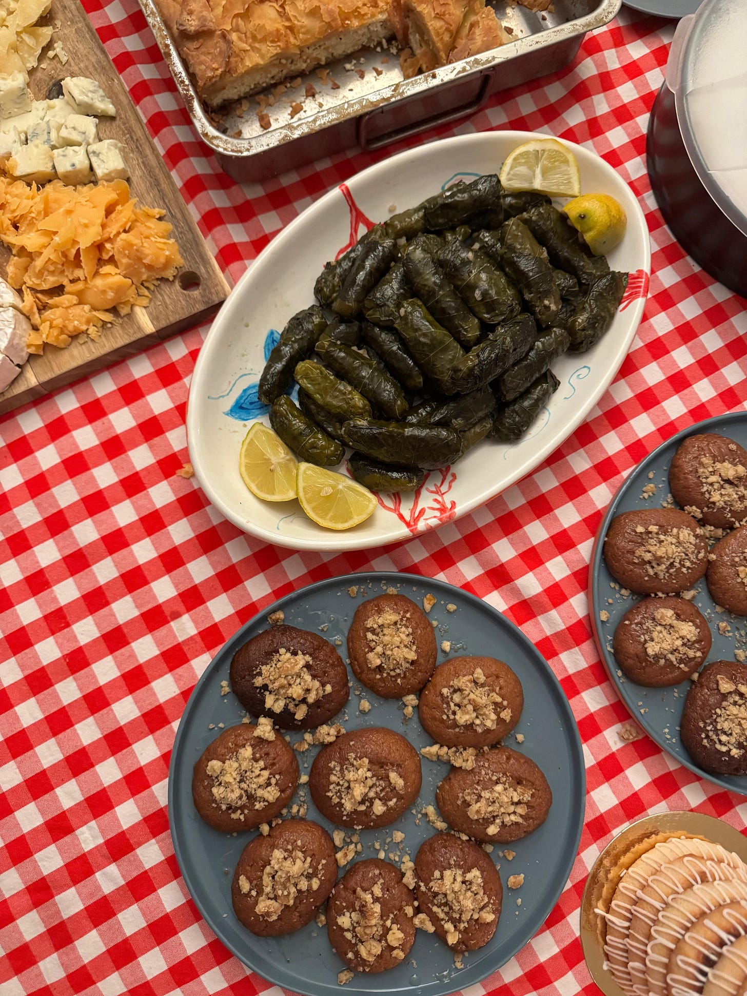christmas table with ntolmadakia, melomakarona and greek cheese pie