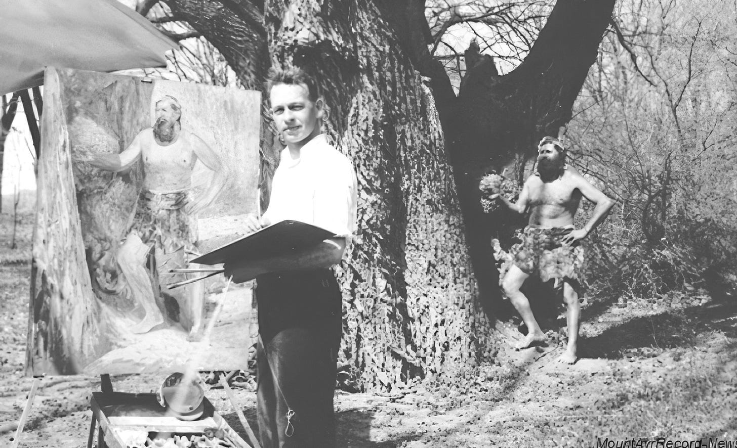 Black-and-white photograph of artist Orr Cleveland Fisher standing beside a tree while painting a life-size portrait of Willie Willey on a large canvas outdoors. The unfinished painting depicts Willey bare-chested and wearing shorts, echoing a second figure of Willey posed nearby in the wooded setting.