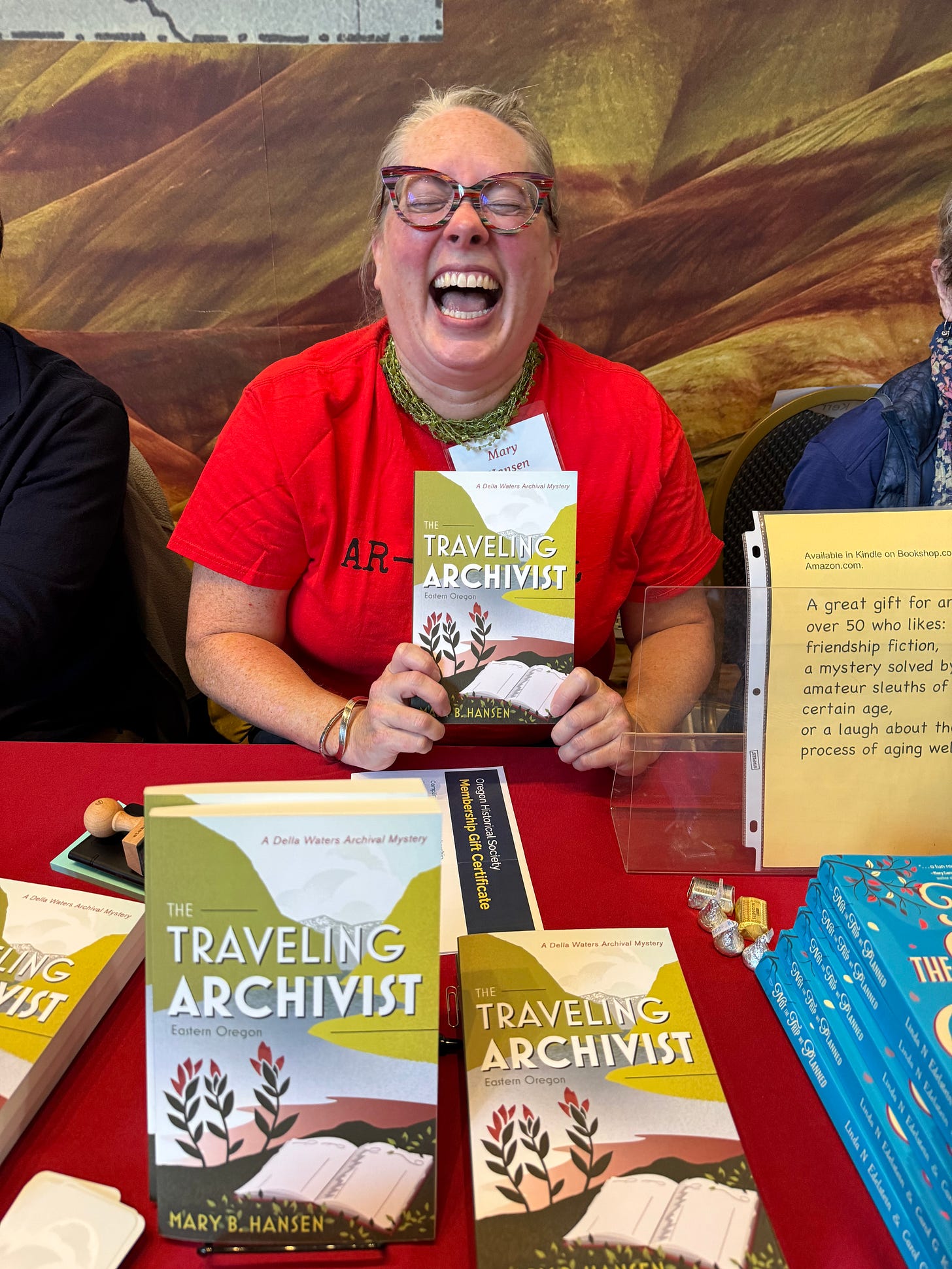 Woman laughing holding a book Woman laughing holding a book