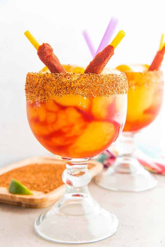Lead image of Mangonadas Margaritas in schooner glasses garnished with tamarind chile straws Lead image of Mangonadas Margaritas in schooner glasses garnished with tamarind chile straws