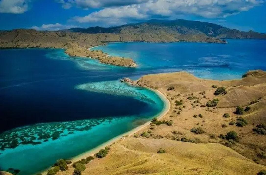 Aerial view of The Cauldron dive site in Komodo National Park, showing the narrow channel where powerful currents flow between sections of the park. Aerial view of The Cauldron dive site in Komodo National Park, showing the narrow channel where powerful currents flow between sections of the park.