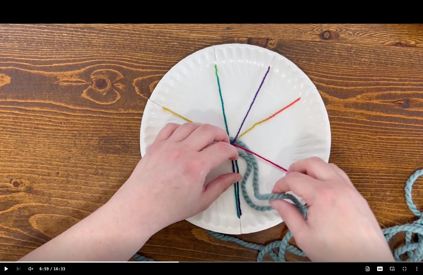 Screenshot of circular weaving tutorial with a paper plate and rainbow yarn