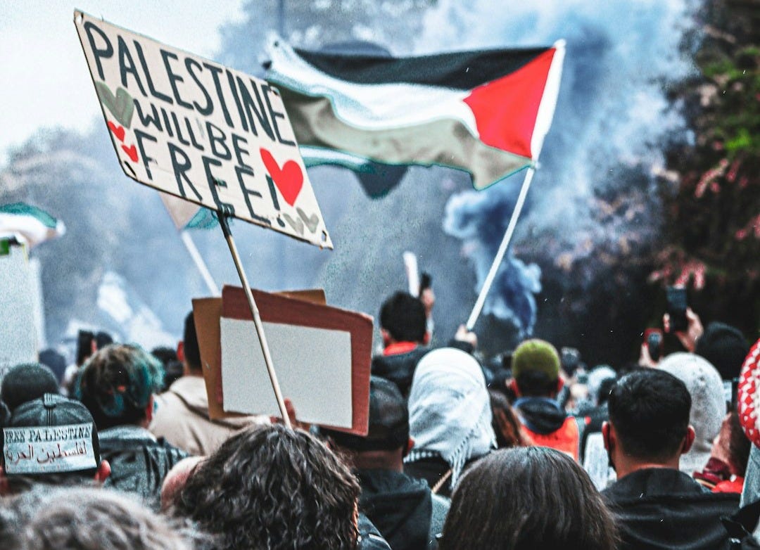 a crowd of people standing around a fire