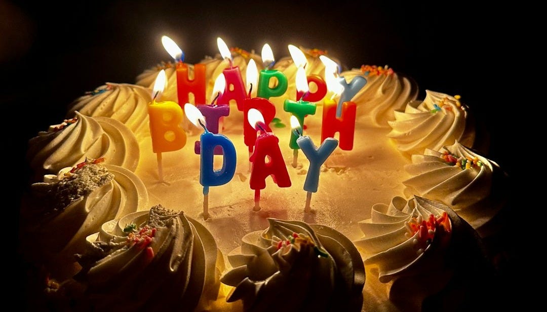 A birthday cake with candles that says happy birthday