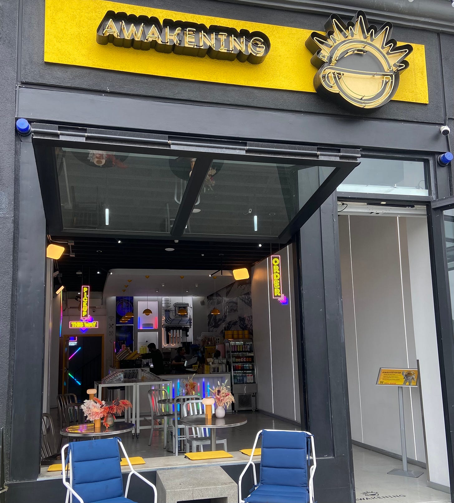  Awakening is a neon flashy storefront with a brand new bright yellow sign, no cash register, windows for doors, and blaring music.  
