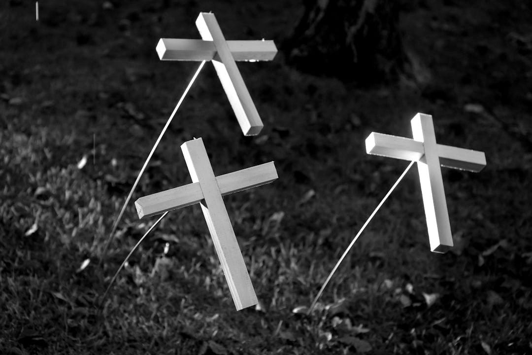white cross on green grass white cross on green grass