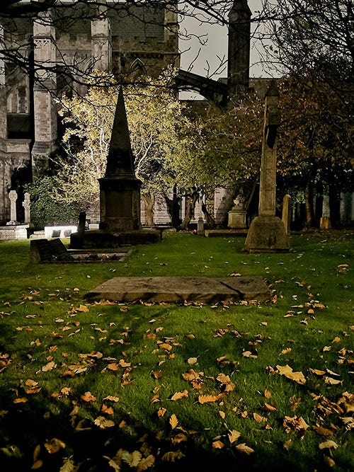 A churchyard at night.