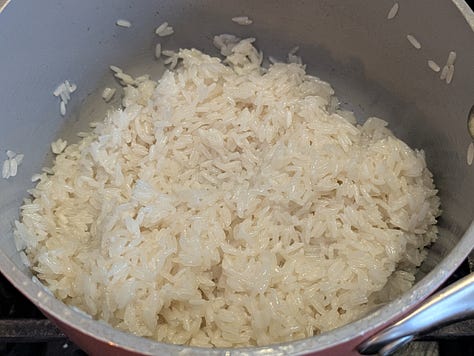 Fresh thai basil used as optional but tasty garnish. Coconut cream can with expected separation. Rice toasting in coconut cream.