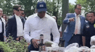 eric adams smelling something an dputting it back on the table