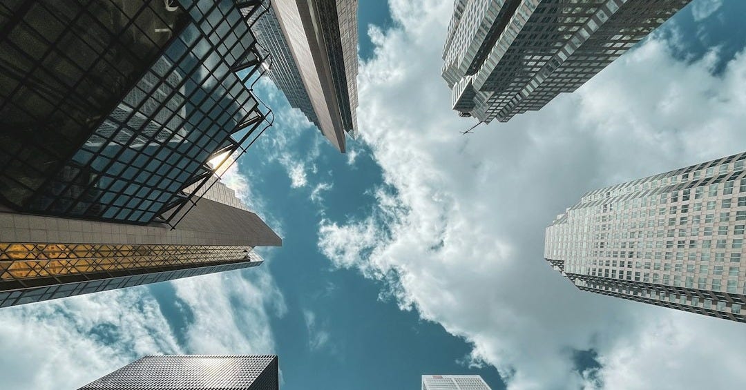 low angle photography of high rise buildings under blue sky during daytime