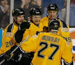 Despite getting another goal from new Bruin Sergei Gonchar -- above center being congratulated by Joe Thornton, above right, Mike Knuble, above left, and Glen Murray -- Andy Hilbert, right, and the Bruins just couldn't grab a win against Serge Aubin (10), goalie Pasi Nurminen and the Thrashers lat night in Boston.