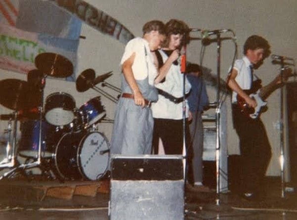 Backing Singers attempt to remember lyrics while thin boy fights with bass Backing Singers attempt to remember lyrics while thin boy fights with bass