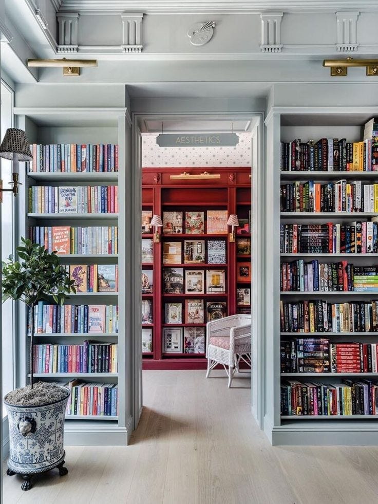 This may contain: a room filled with lots of books on top of shelves next to a potted plant