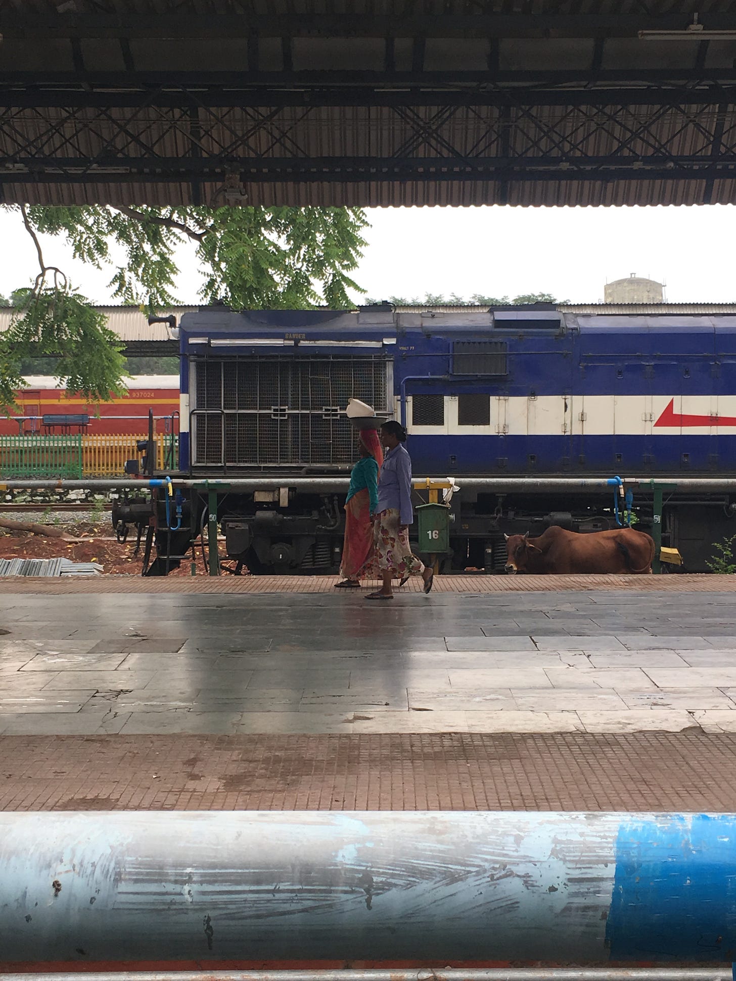 two women walking at an Indian train station