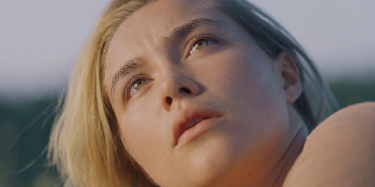 A close-up shot of Dani looking into the sun, her eyes glowing.