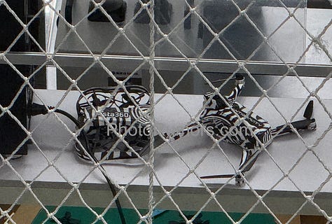 Leaked photos of two prototype drones reportedly developed by Insta360. One features a foldable frame with zebra camouflage and a dual-lens 360° camera module labeled “ANTIGRAVITY.” The second is a compact FPV-style drone with ducted fans, designed for agile or indoor flight. Close-up shots reveal modular components and panoramic imaging systems that mirror Insta360’s patented designs. The images are believed to originate from a private field test and align with newly disclosed corporate and investor filings.