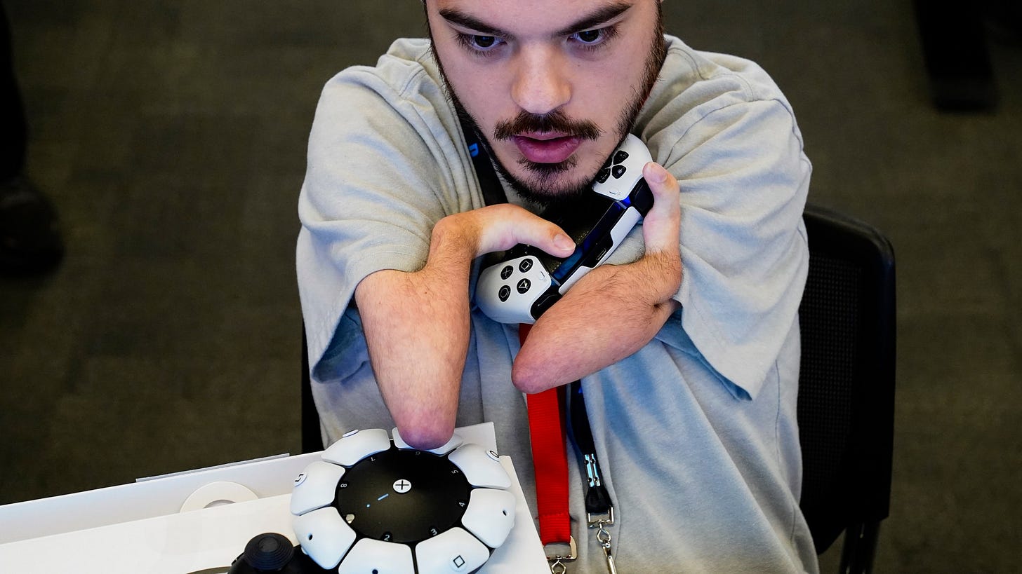 Martin Shane uses a Sony Access controller, left, to play a video game at Sony Interactive Entertainment headquarters Thursday, Sept. 28, 2023, in San Mateo, Calif. (AP Photo/Godofredo A. Vásquez)